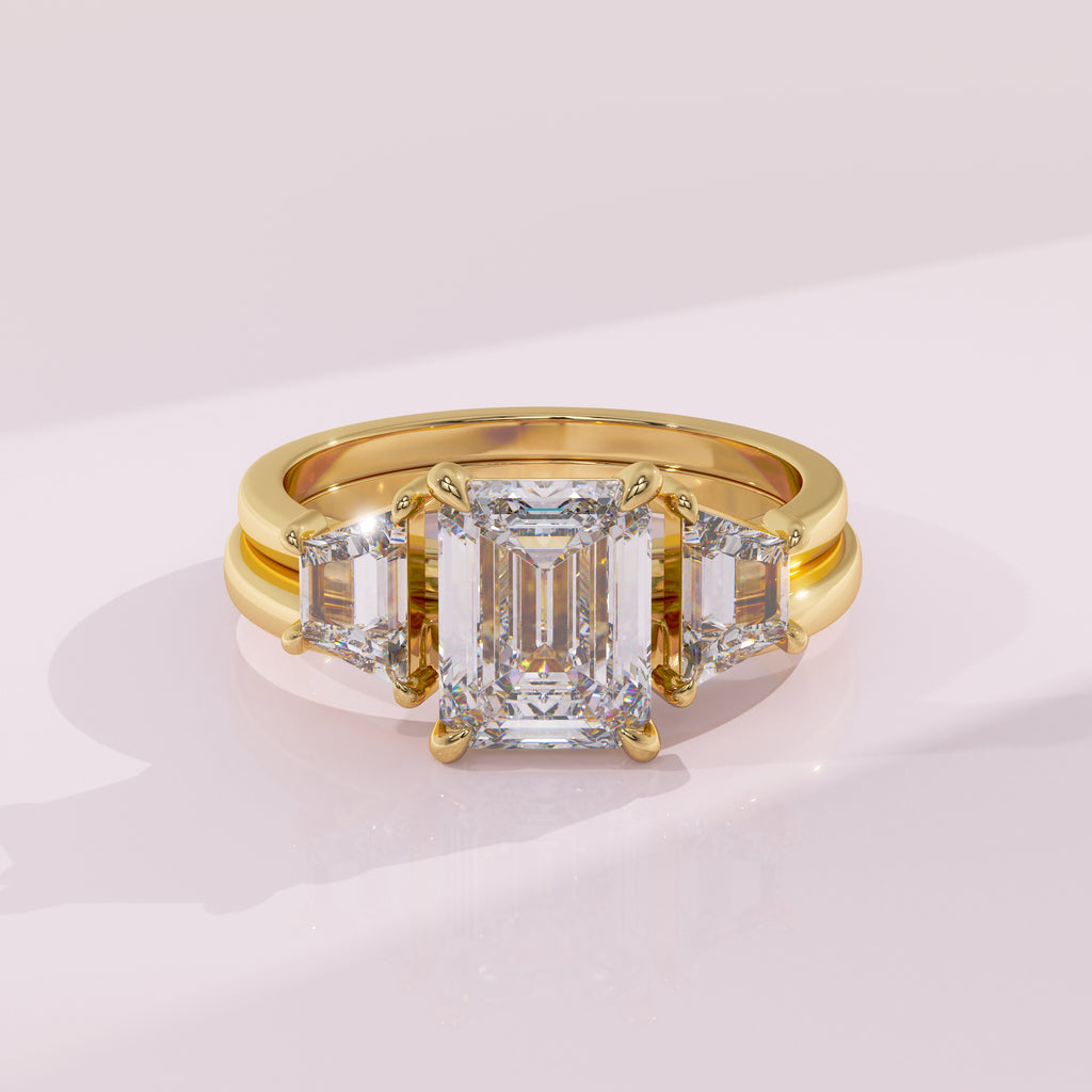 Gold ring with a large diamond and smaller diamonds on a light pink background