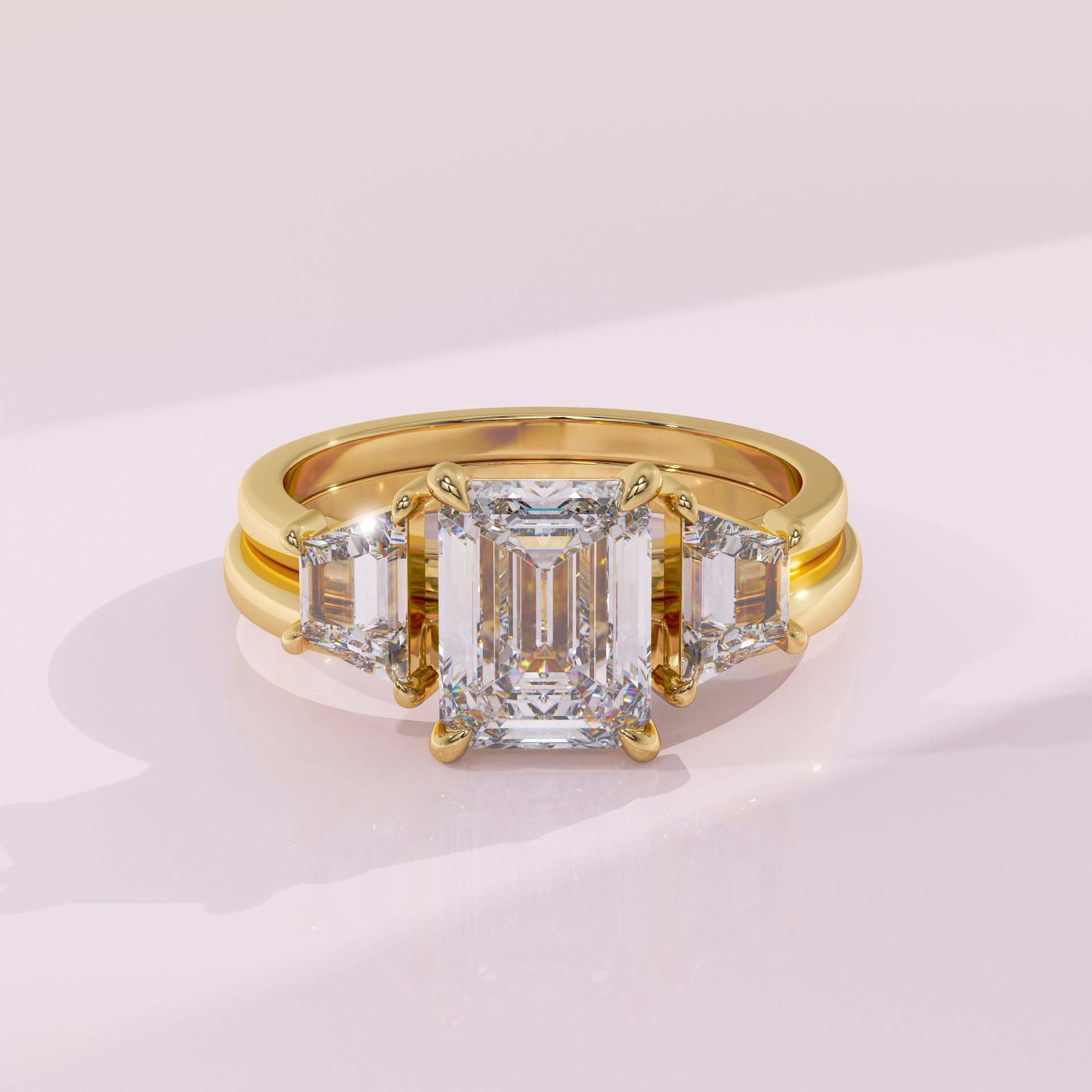 Gold ring with a large diamond and smaller diamonds on a light pink background