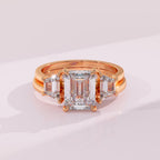 Rose gold ring with a large diamond and smaller diamonds on a light background