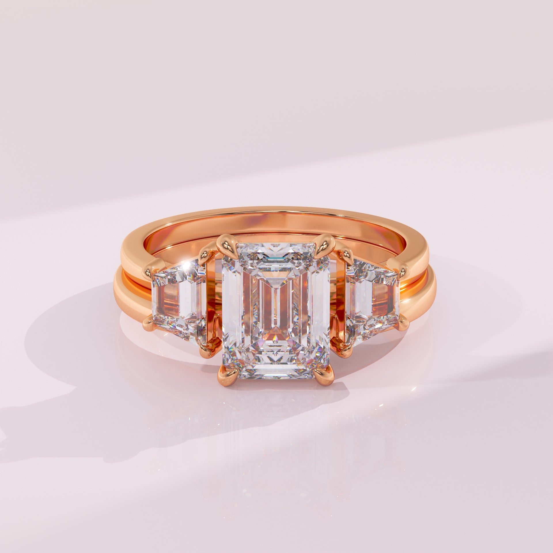 Rose gold ring with a large diamond and smaller diamonds on a light background