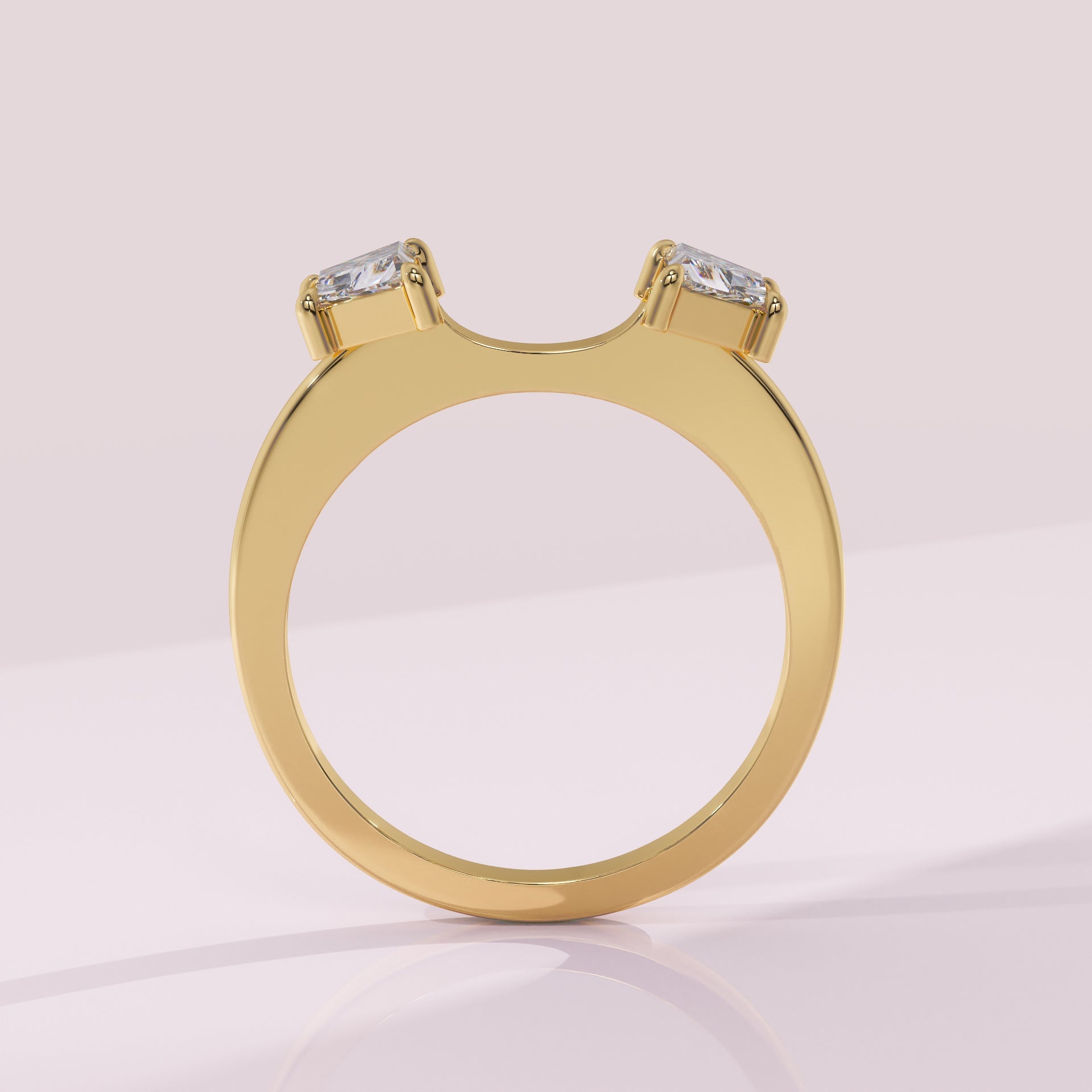 Gold ring with two diamond stones on a light pink background