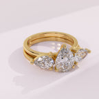 Pear cut moissanite guard ring designed to enhance a solitaire engagement ring