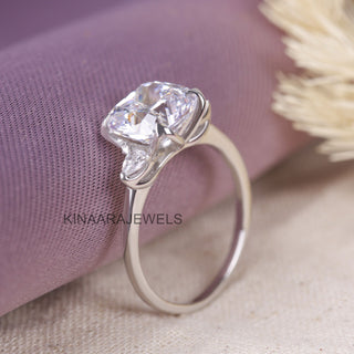 cushion cut with pear cut moissanite three stones ring